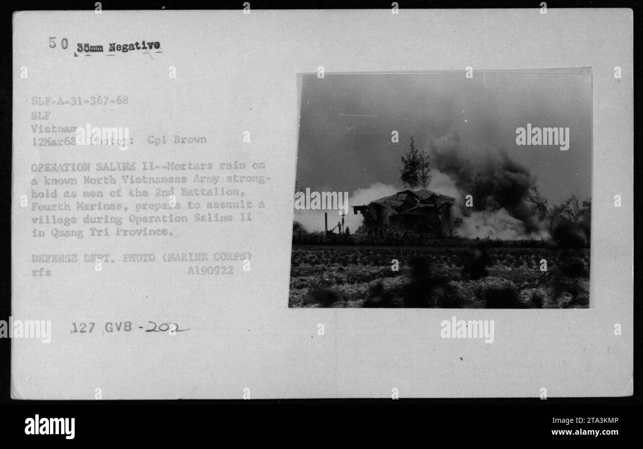 Men of the 2nd Battalion, 4th Marines engage in Operation Saline II in Quang Tri Province on March 12, 1968. The image shows explosions and fires as mortars are launched at a North Vietnamese Army stronghold. The photograph was taken by Cpl Brown and is part of the official 35mm negative collection of the U.S. military. Stock Photo