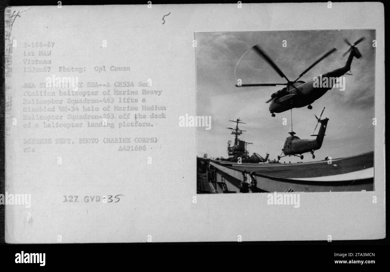 A CH53A Sea Stallion helicopter of Marine Heavy Helicopter Squadron-463 is seen lifting a disabled UH-34 helicopter of Marine Medium Helicopter Squadron-263 off the deck of a helicopter landing platform during air delivery and troop drops operations on June 15, 1967 in Vietnam. Photograph taken by Cpl Cowen. This is an official Defense Department photo. Stock Photo