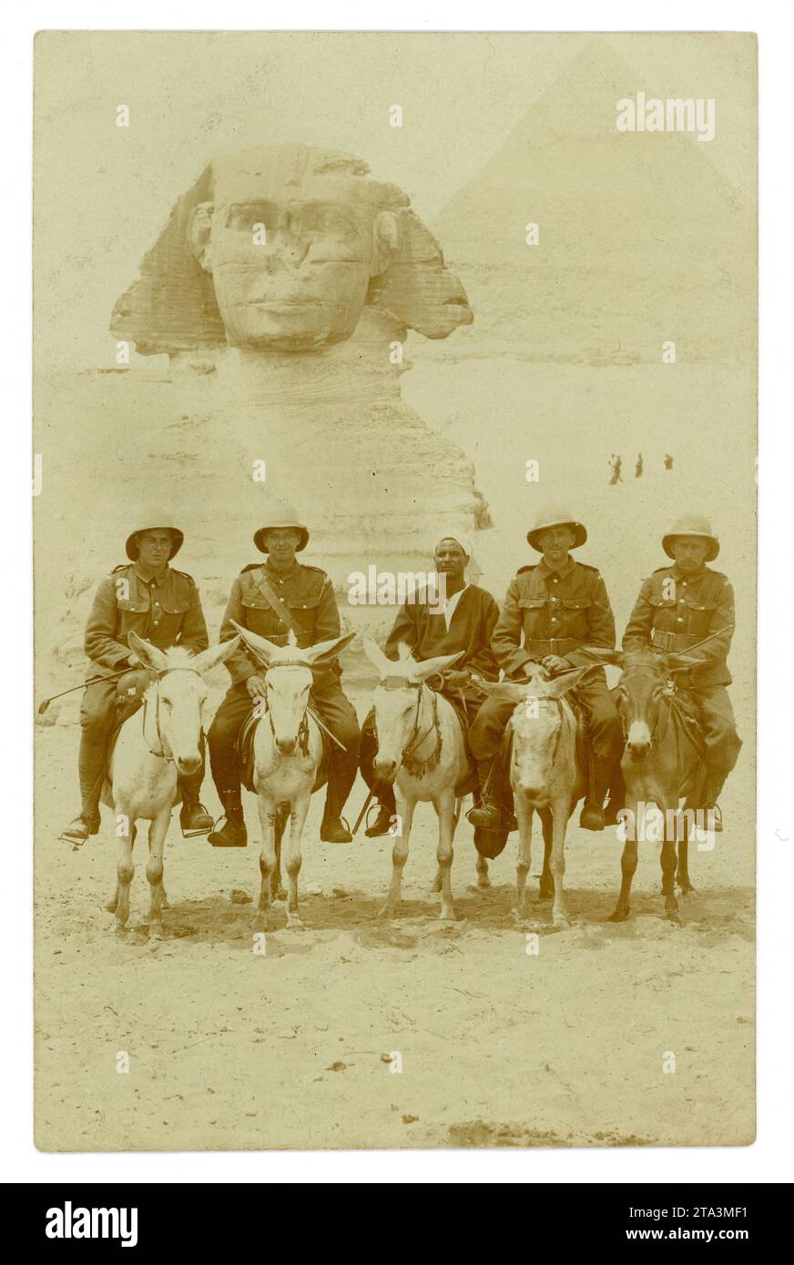 Original WW1 era postcard of soldiers on donkeys posing in front of the Great Sphinx with the Great Pyramid behind, at Giza. Sightseeing. There is a native guide in the middle. On reverse it states 'April 1916 Egypt, To Florrie from Corporal H. Jones and Corporal G. Jones', maybe brothers, reverse. Perhaps they are members of the Egyptian Expeditionary Force (EFF)  Possibly they are Welsh.  Photo taken at Giza, Cairo, North Africa, Stock Photo