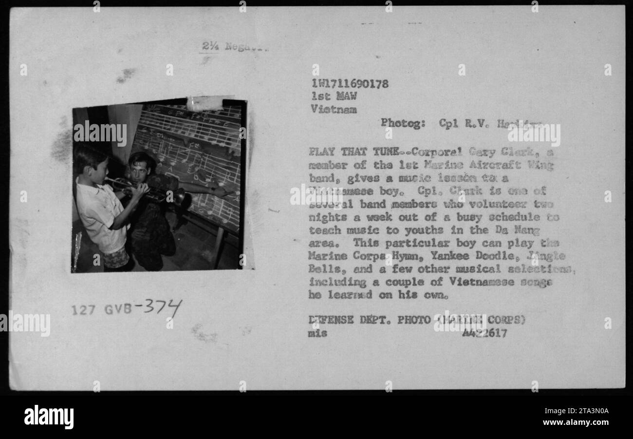 1st Marine Aircraft Wing band member, Cpl Cary Clark, giving a music lesson to a Vietnamese boy in Da Nang during the Vietnam War. Clark and other band members volunteer their time two nights a week to teach music to local youths. The boy can play the Marine Corps Hymn, Yankee Doodle, Jingle Bells, and a few Vietnamese songs he learned on his own. Stock Photo