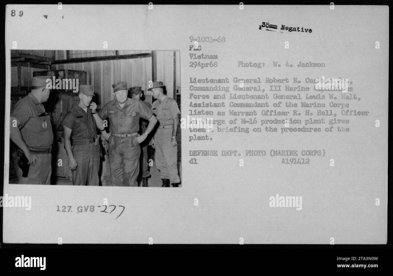 Lieutenant General Robert E. Cushman Jr., Commanding General, III Marine Amphibious Force and Lieutenant General Lewis W. Walt, Assistant Commandant of the Marine Corps listen to Warrant Officer E. H. Bell, Officer in Charge of M-16 production plant, giving them a briefing on plant procedures. Photograph taken on April 29, 1968 in Vietnam by W. A. Jackson. Stock Photo