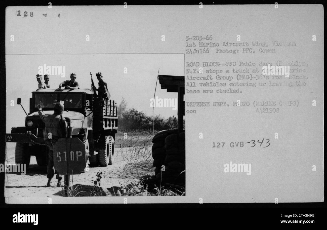 On July 24, 1966, PFC Pablo Sacs from Boldyn, N.Y., stops a truck at a roadblock set up by the 1st Marine Aircraft Wing in Vietnam. This roadblock, established by Marine Aircraft Group (MAG)-36, checks all vehicles entering or leaving the base. The photograph was taken by PPC Cowen and is part of the Defense Department collection. Stock Photo