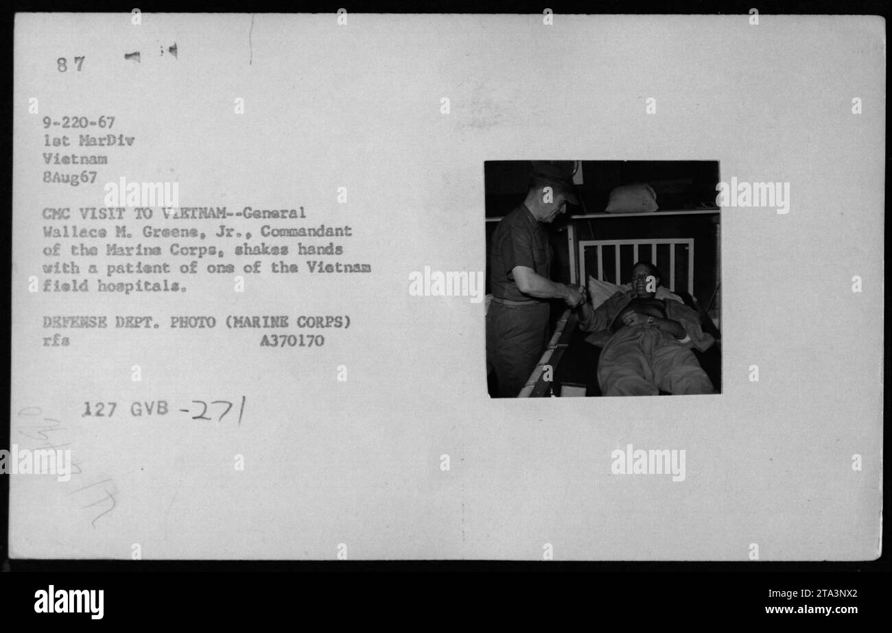 General Wallace M. Greene, Jr., Commandant of the Marine Corps, shakes hands with a patient at a Vietnam field hospital during his visit to Vietnam on August 8, 1967. This photograph captures the interaction between military officials and individuals receiving medical care during the Vietnam War. Stock Photo