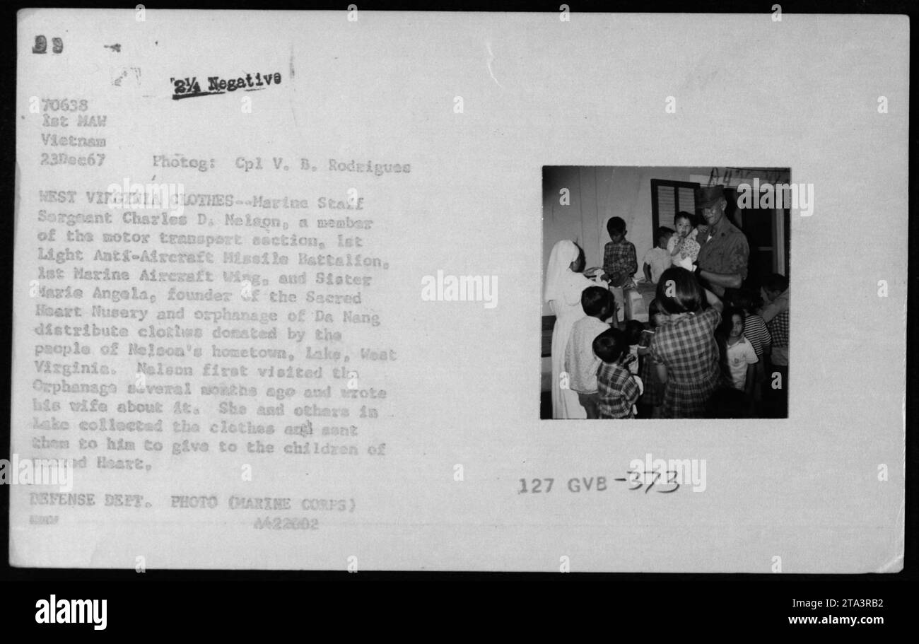 Marine Staff Sergeant Charles D. Melson, along with Sister Marie Angela, the founder of the Sacred Heart Museum and Orphanage in Da Nang, distribute clothes donated by the people of Melson's hometown, Lake, West Virginia. Melson visited the orphanage and wrote to his wife about it. The clothes were sent by the people of Lake to be given to the children of Sacred Heart. Stock Photo