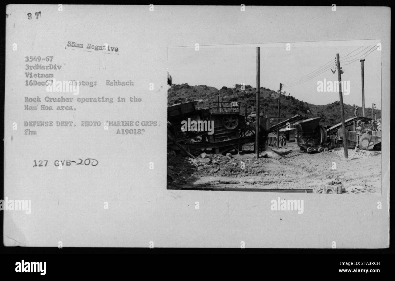 A Marine Corps Rock Crusher in operation in the Naa Hoa area during the Vietnam War. The photograph, taken on December 16, 1967, showcases the military equipment used in construction activities. This image is a 35mm negative held by the Defense Department, showcasing the day-to-day activities of American troops during the conflict. Stock Photo