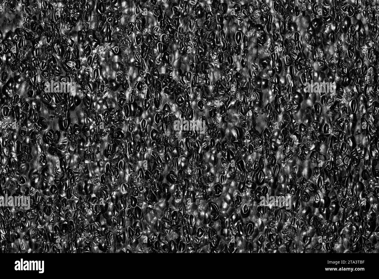 Black Expanded polyethylene foam sample background. EPE beads packing