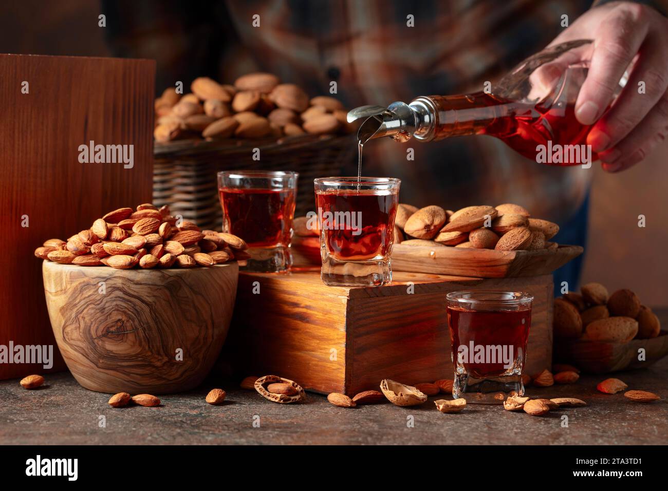 Italian liqueur Amaretto with almonds nuts on a vintage table. Liqueur