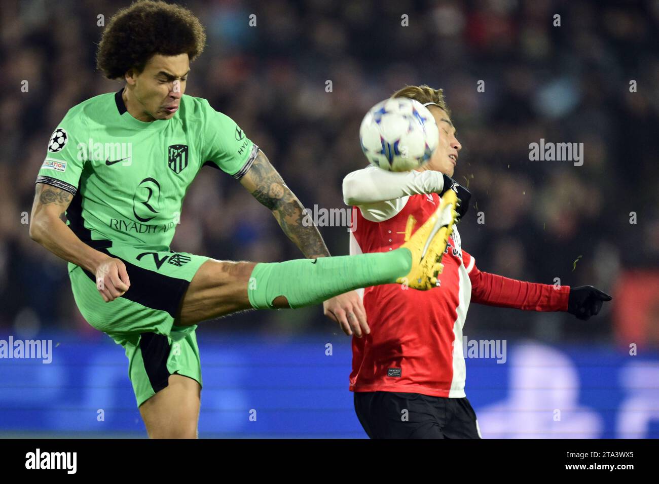 ROTTERDAM - 28/11/2023, ROTTERDAM - (l-r) Axel Witsel of Atletico Madrid, Ayase Ueda of Feyenoord during the UEFA Champions League group E match between Feyenoord and Atletico Madrid at Feyenoord Stadion de Kuip on November 28, 2023 in Rotterdam, Netherlands. ANP OLAF KRAAK Stock Photo