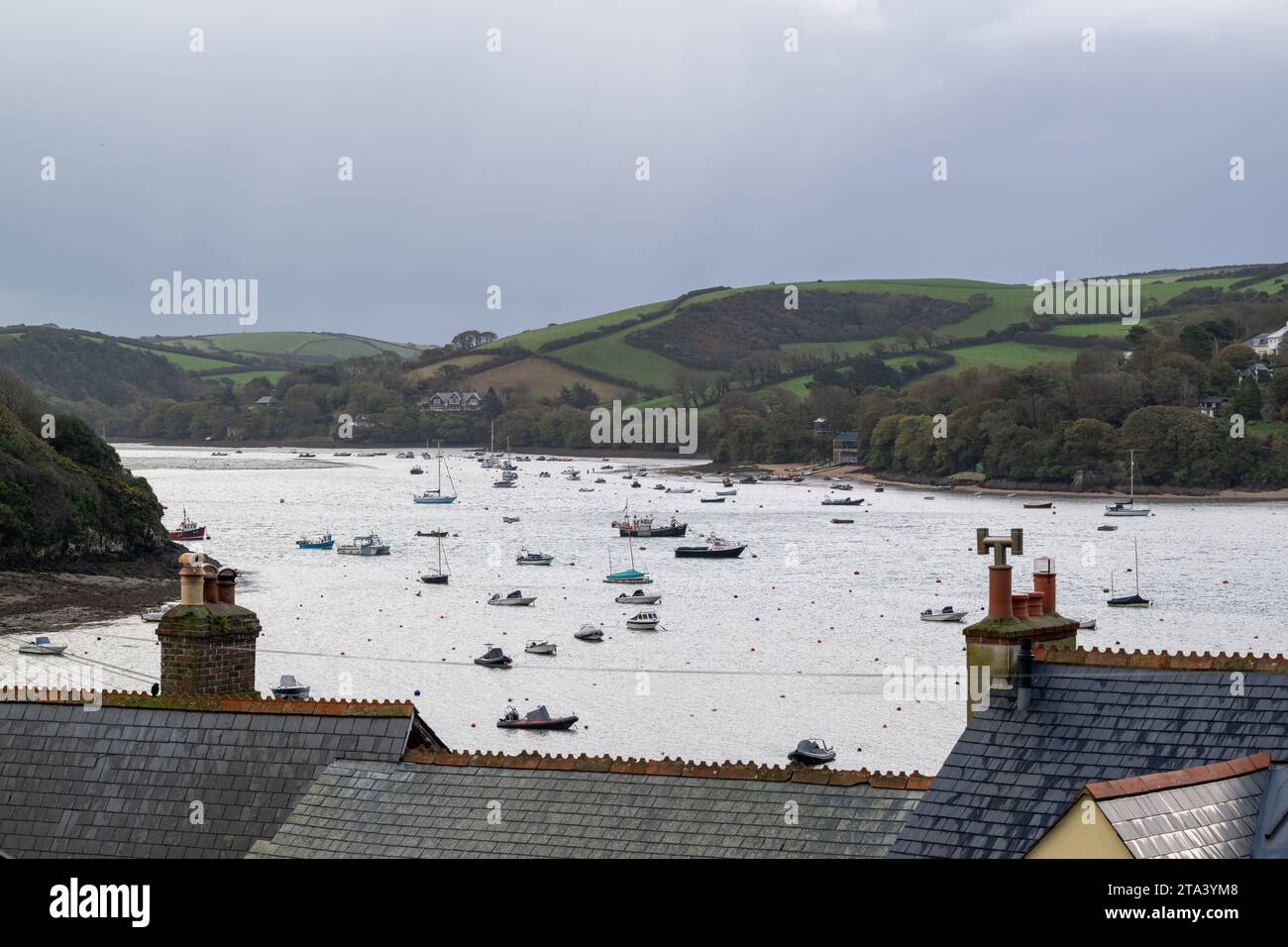 View along Salcombe estuary, Snapes point on the left, East Portlemouth on the right and roofs in the foreground with the water emptying for winter. Stock Photo