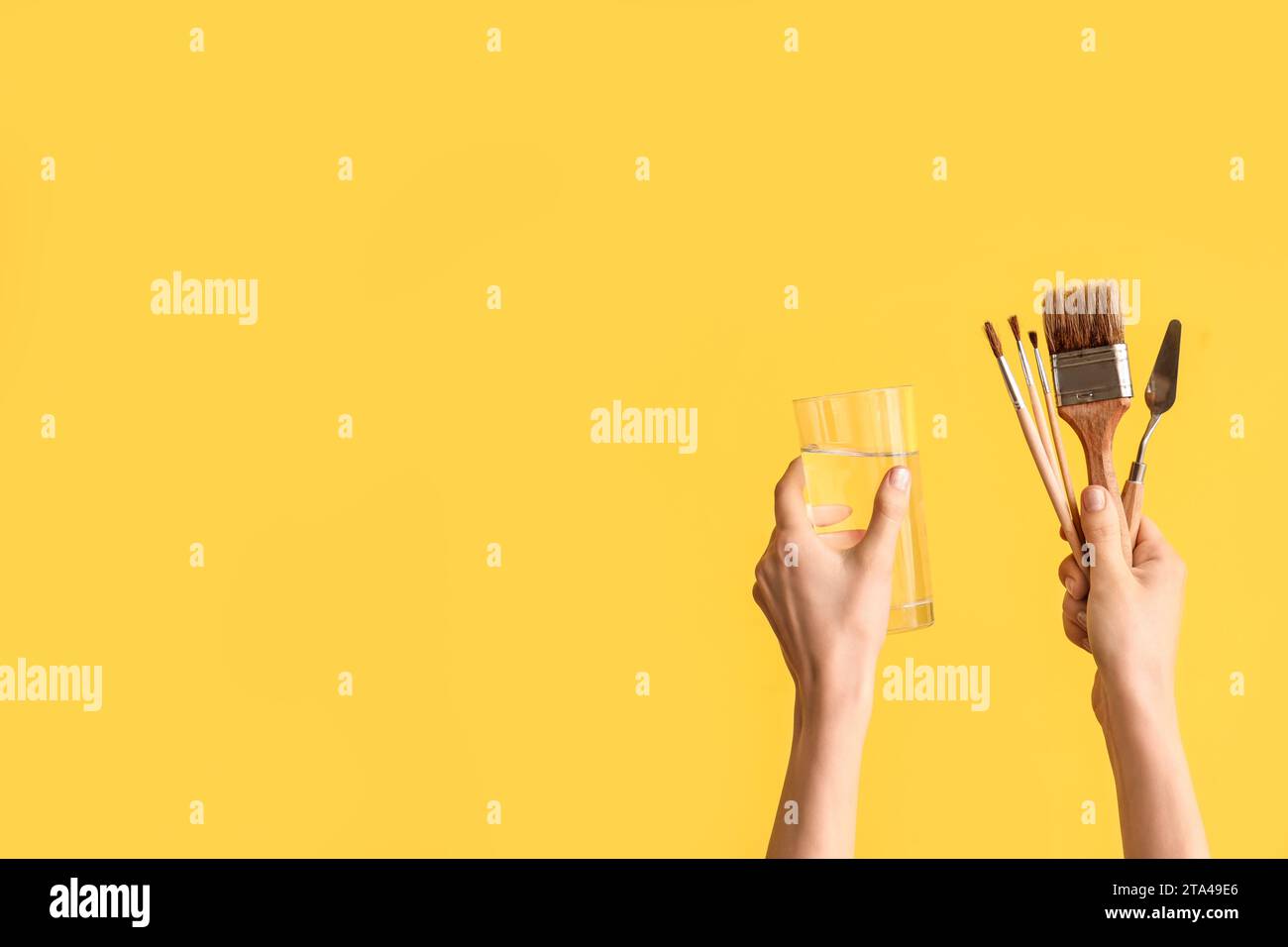 Female hands with artist's supplies on yellow background Stock Photo ...