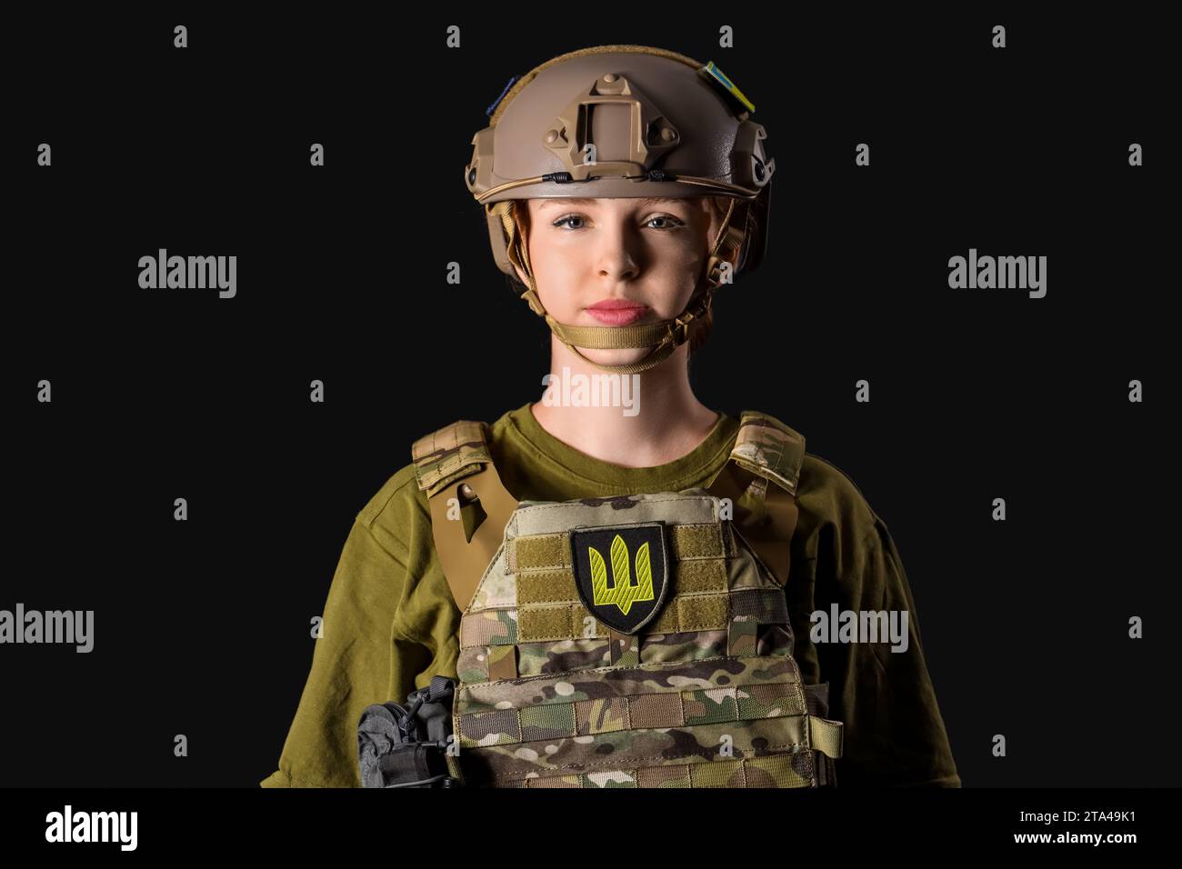 Young female soldier on black background Stock Photo - Alamy