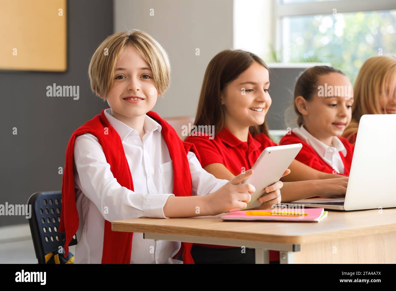 Little boy studying with tablet at school computer lab Stock Photo - Alamy