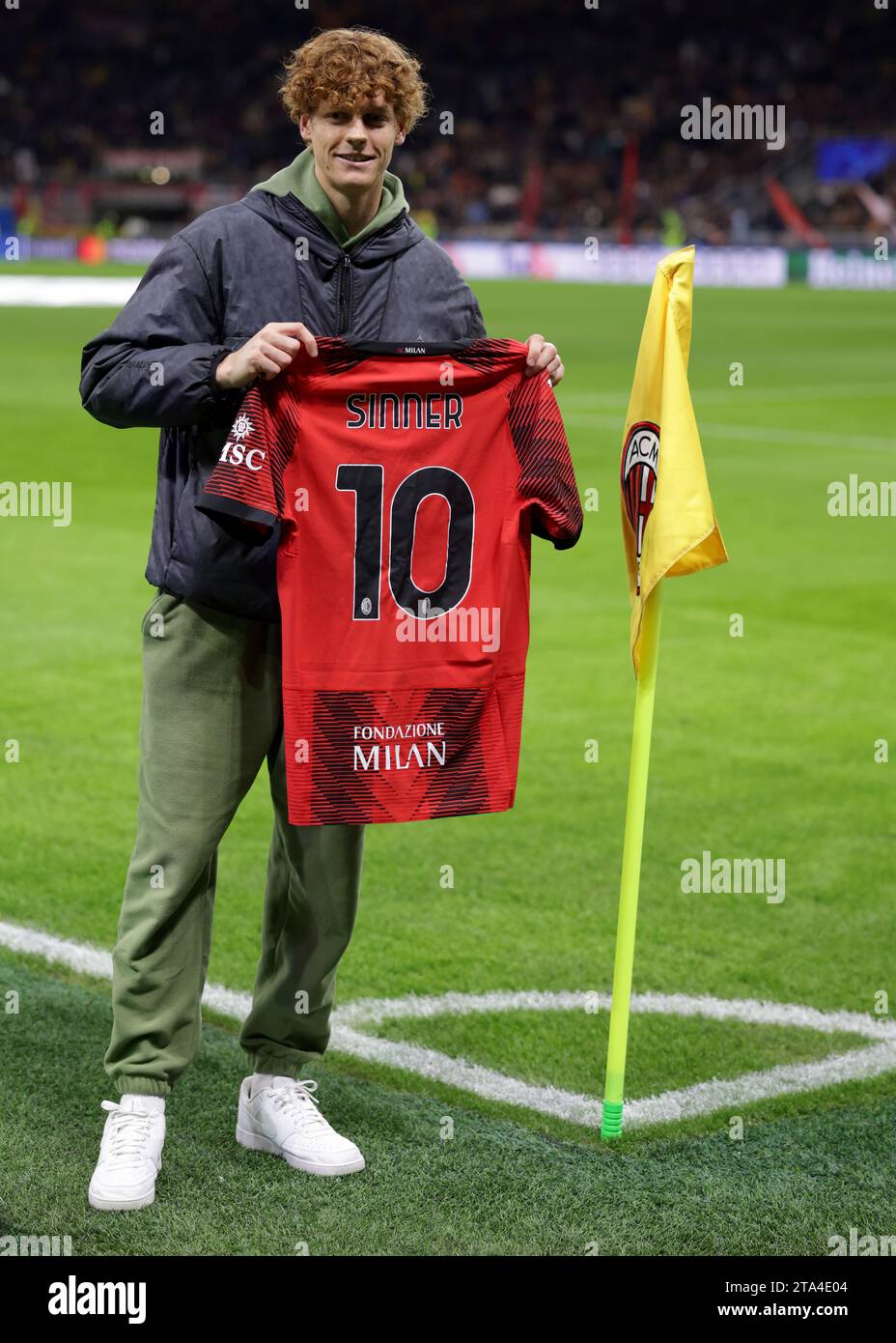 Milan, Italy. 28th Nov, 2023. Italian Tennis player and Winner of the 2023 Davis Cup, Jannick Sinner poses with an AC Milan jersey at the corner flag prior to the UEFA Champions League match at Giuseppe Meazza, Milan. Picture credit should read: Jonathan Moscrop/Sportimage Credit: Sportimage Ltd/Alamy Live News Stock Photo