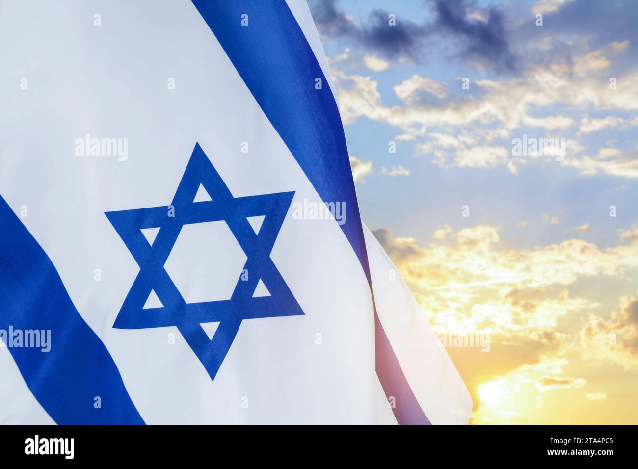 National flag of Israel against blue sky with clouds Stock Photo - Alamy