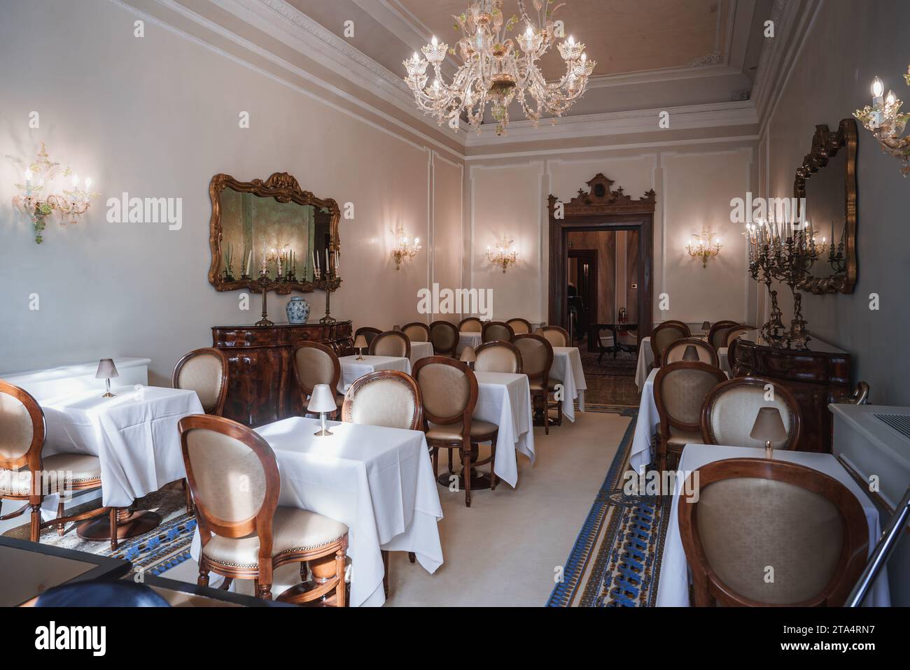 Elegant and luxurious restaurant interior with white tables, chairs