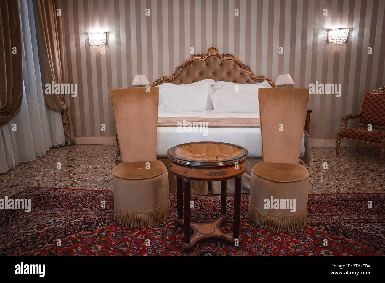 Luxurious Bedroom with Elegant White Bed, Chairs, and Rug in