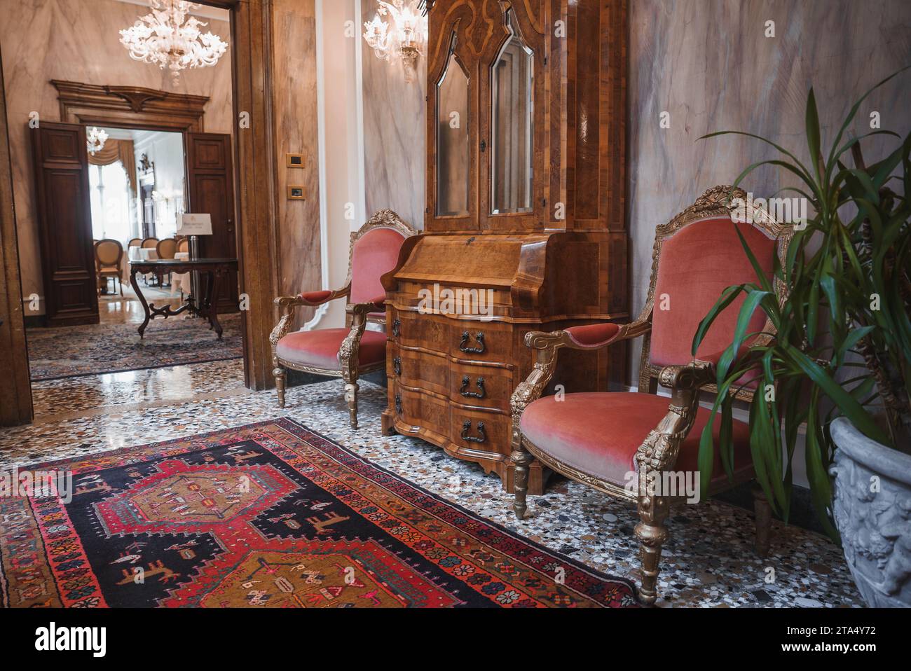 Luxury Hotel Lobby with Ornate Decor, Chandeliers, and Oriental Rugs in Venice, Italy Stock