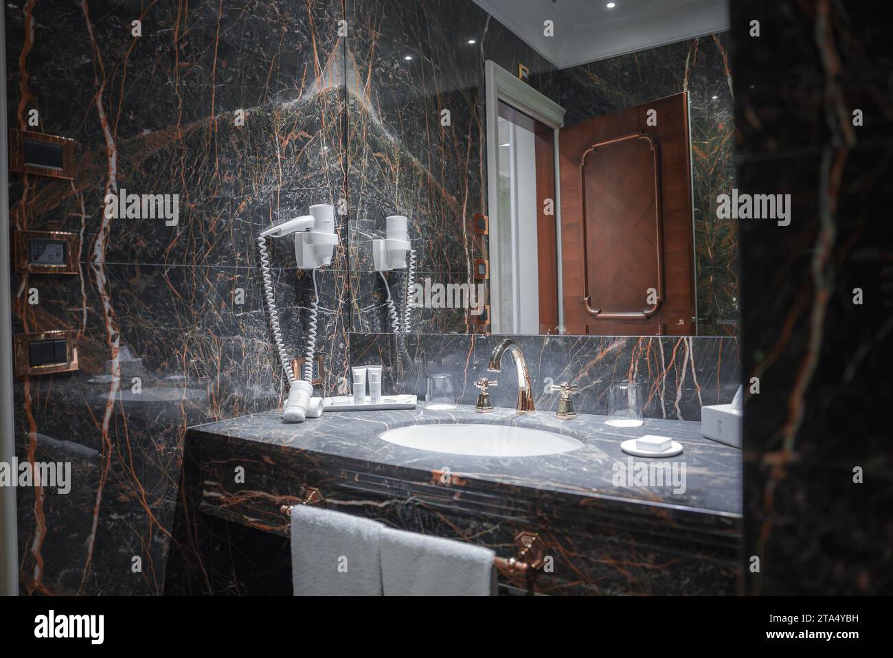 Luxurious Black Marble Bathroom with White Sink and Mirror in Venetian ...