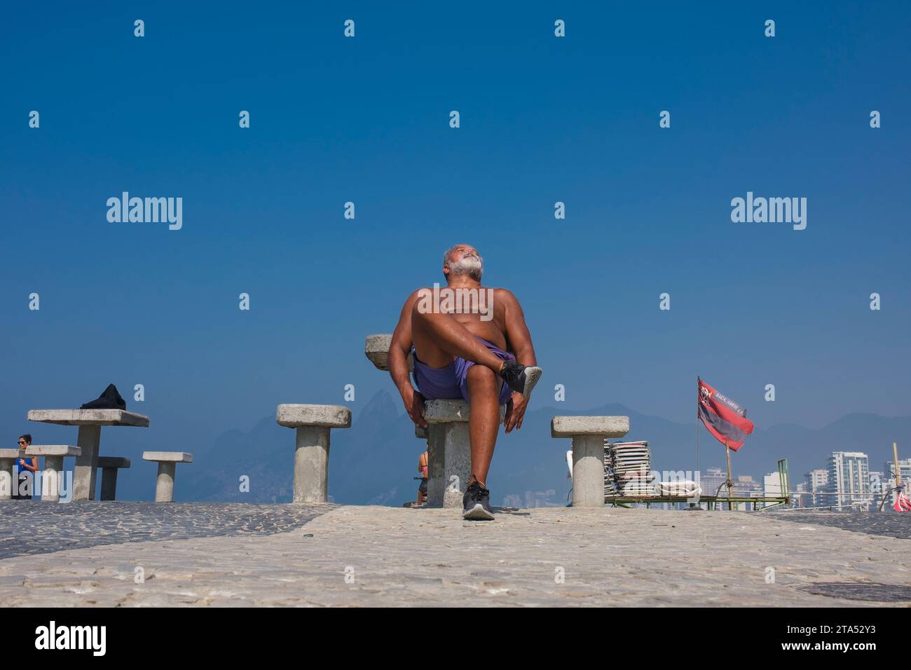 Retired man enjoys a sunny morning at Arpoador beach. Rio de Janeiro ...