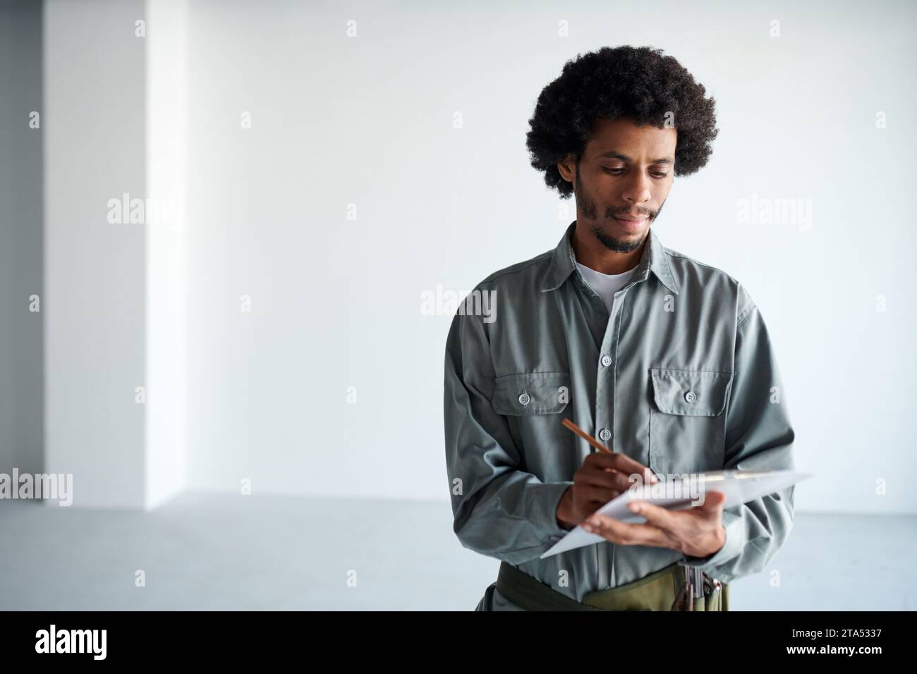 Foreman taking notes when inspecting construction site Stock Photo