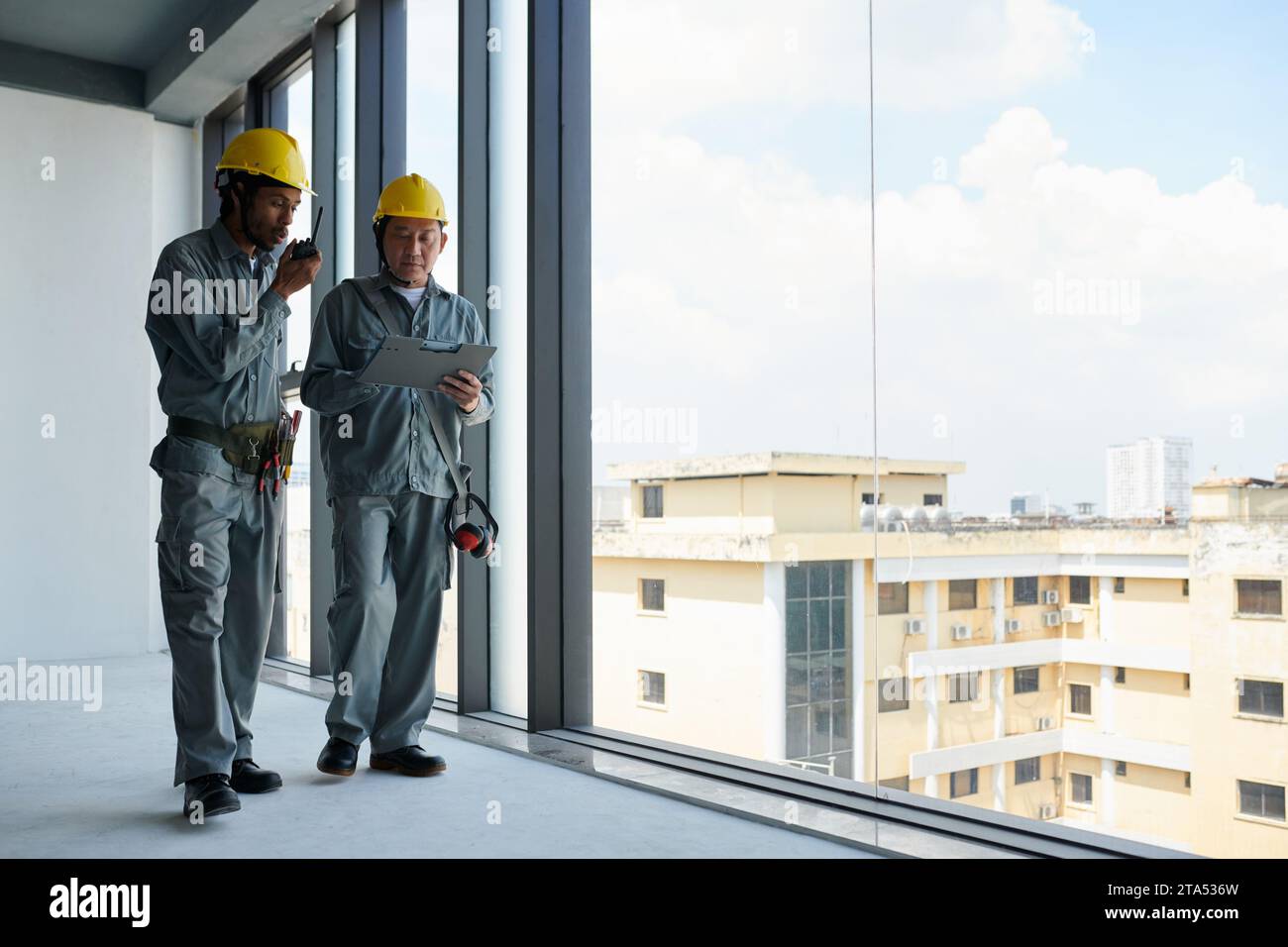 Engineer and contractor managing work at construction site Stock Photo