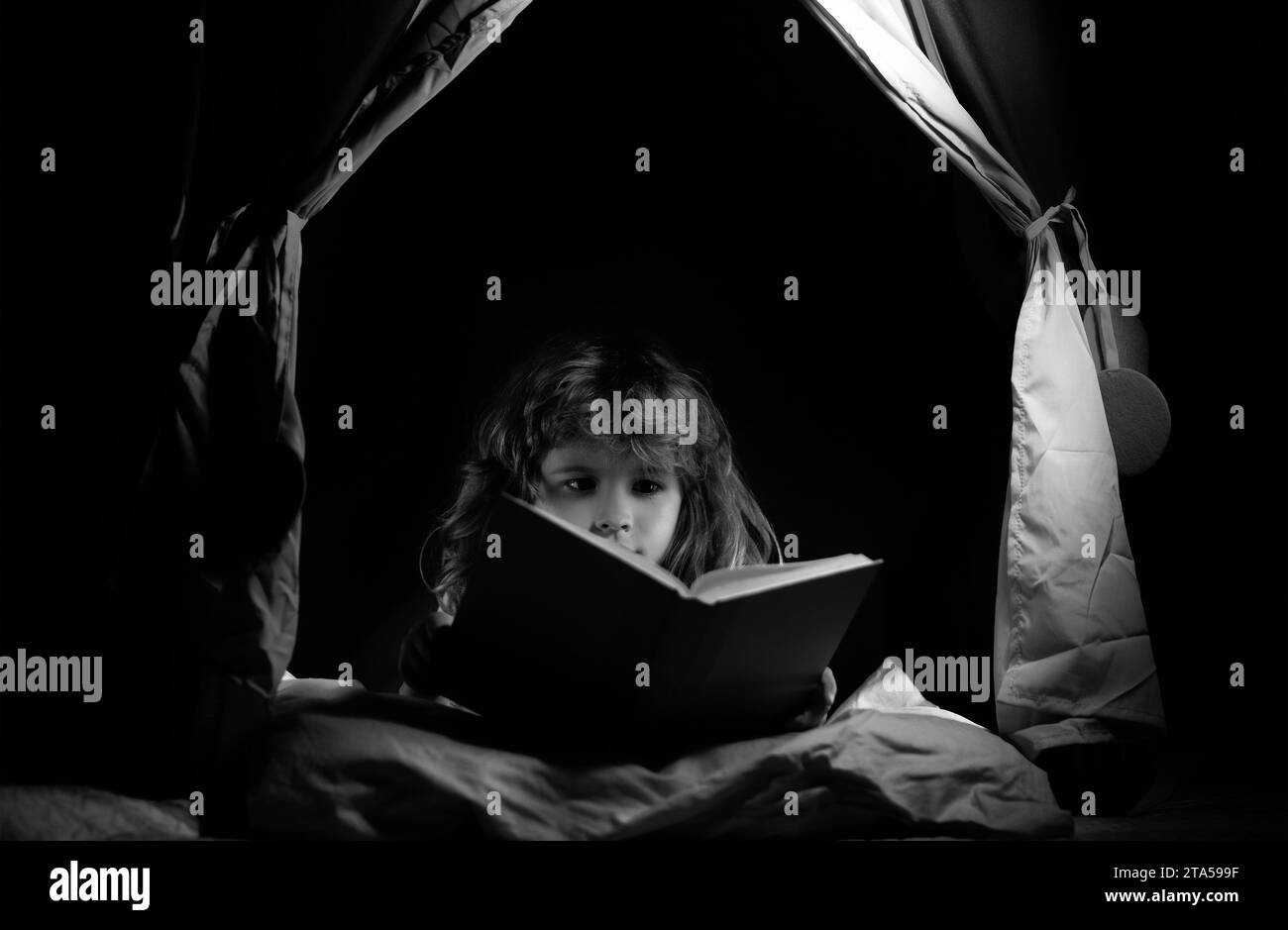 Kids in kids tent reading books. Child reading story with book. Kids