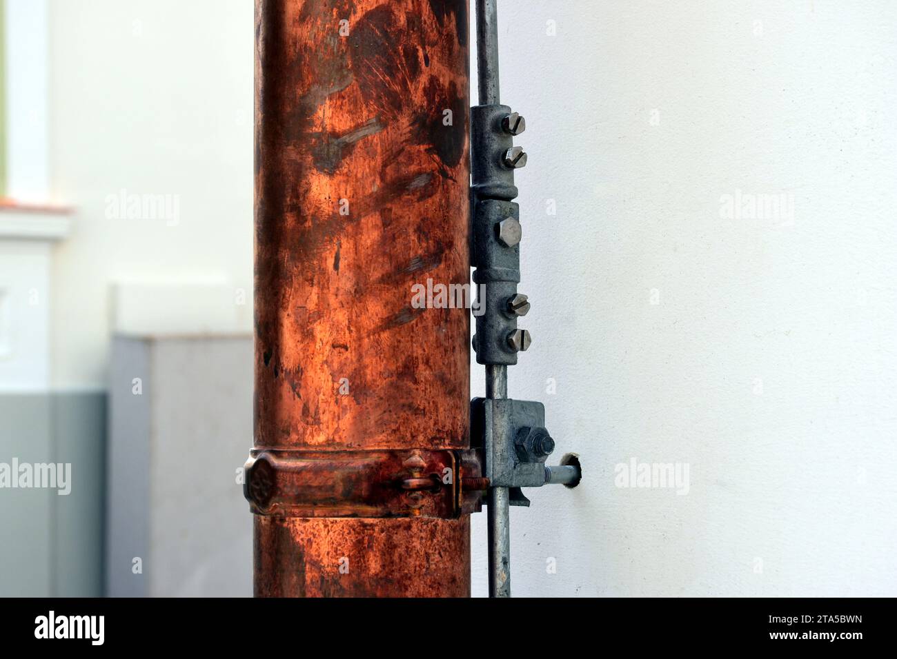 shiny new copper rain water leader, downspout or down pipe detail