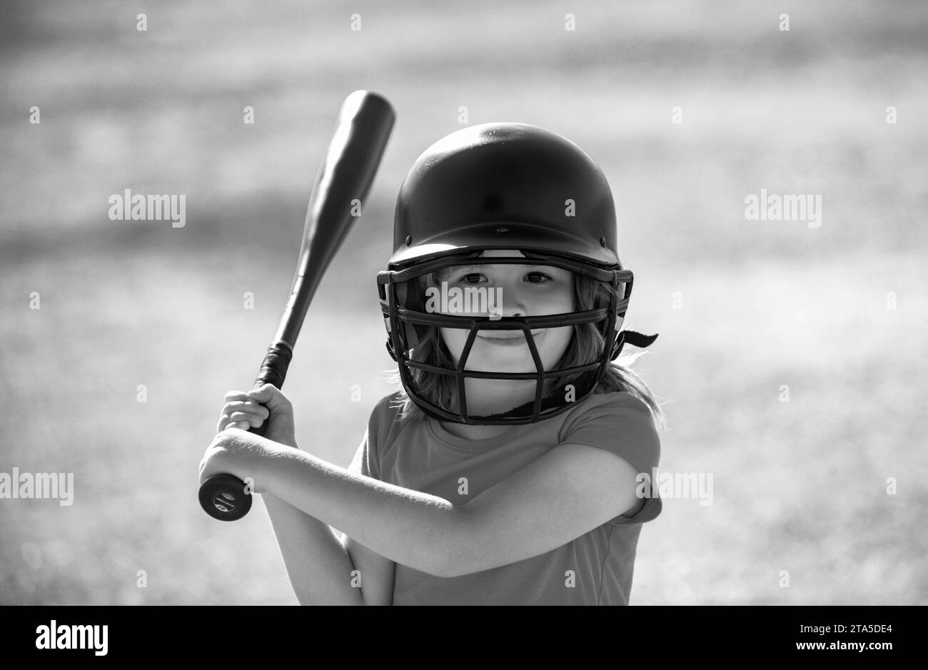 Little child baseball player focused ready to bat. Kid holding a