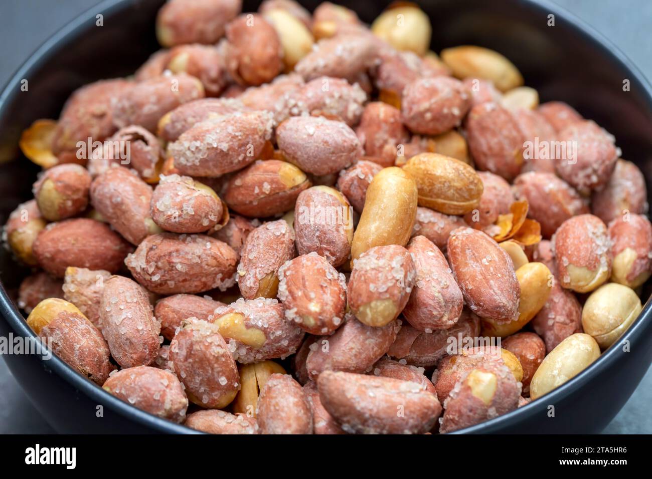 Salted peanuts in a glass bowl Stock Photo