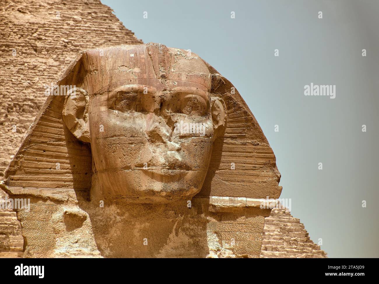 A majestic sphinx sculpture stands guard in front of the iconic