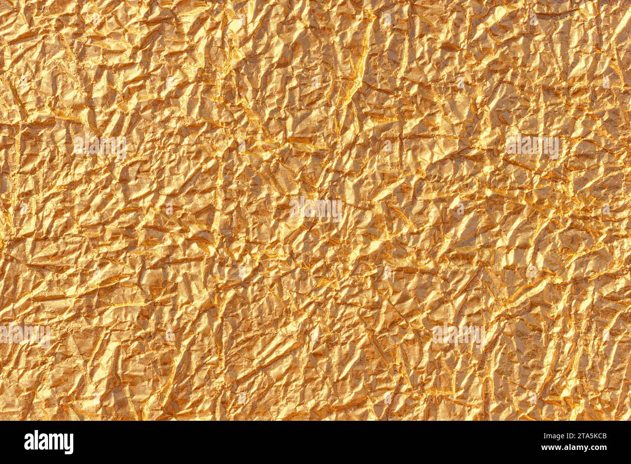 Golden Foil Background. Abstract Wrinkled Texture Pattern. Metallic Wrap Paper Texture Or Backdrop. Stock Photo