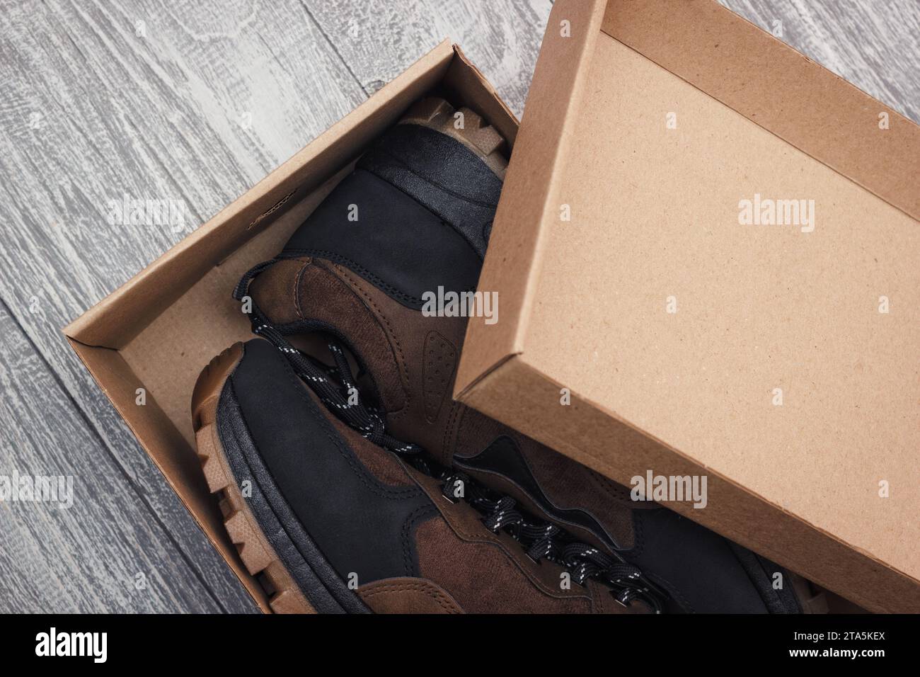 Open The Box With A Pair Of New Shoes. Closeup View On The Purchased Footwear In Paper Package. Stock Photo