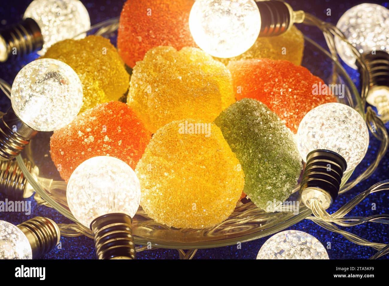 Yummy Flavored Jelly Candies With Holidays Illumination. Closeup View On Plate With Fruity Marmalade. Stock Photo