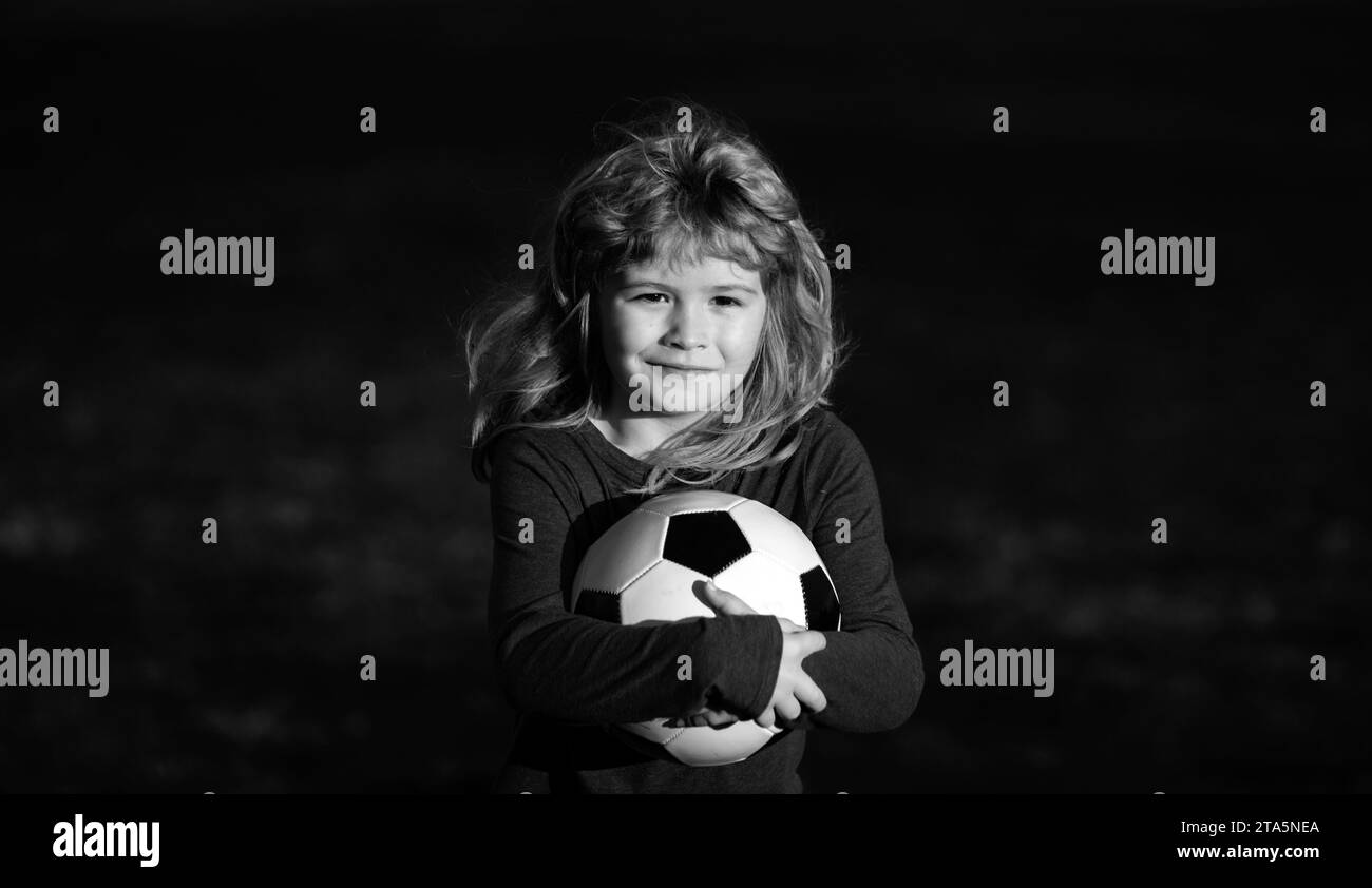 Soccer boy, child play football. Kid holding soccer ball, closeup kids portrait Stock Photo Alamy