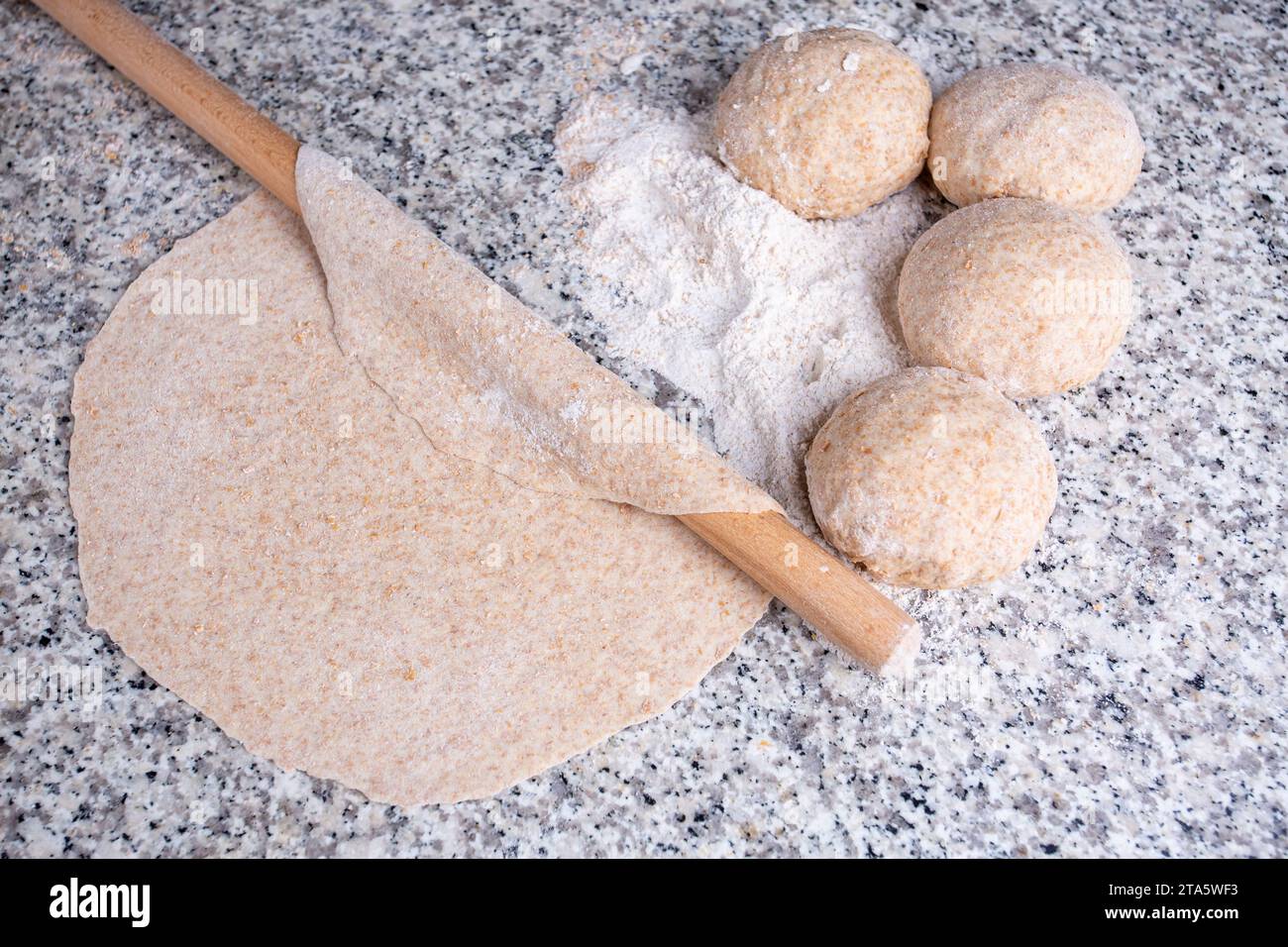 Turkish style making bread with a rolling pin, yeast dough (Turkish name; hamur acmak) Stock Photo