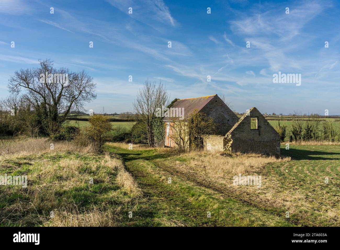 Semi derelict old stone barn in the fields outside the village of Easton Maudit, Northamptonshire, UK Stock Photo