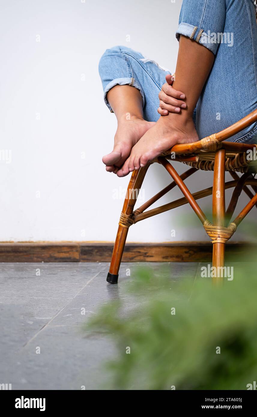 Woman sitting on chair in patio hi-res stock photography and images - Alamy