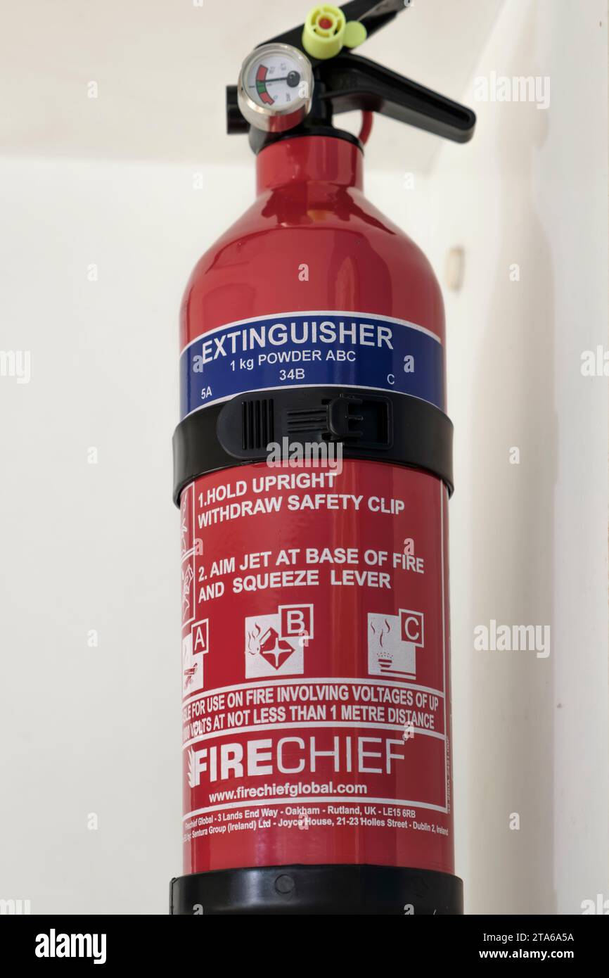 Domestic fire extinguisher on a kitchen shelf. Stock Photo