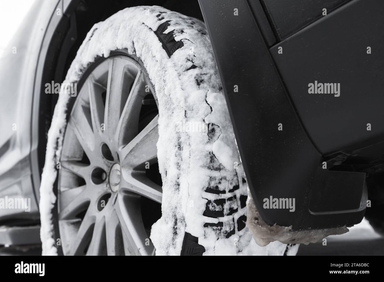 SUV car wheel on snow tire with metal studs. Close-up photo with selective focus Stock Photo