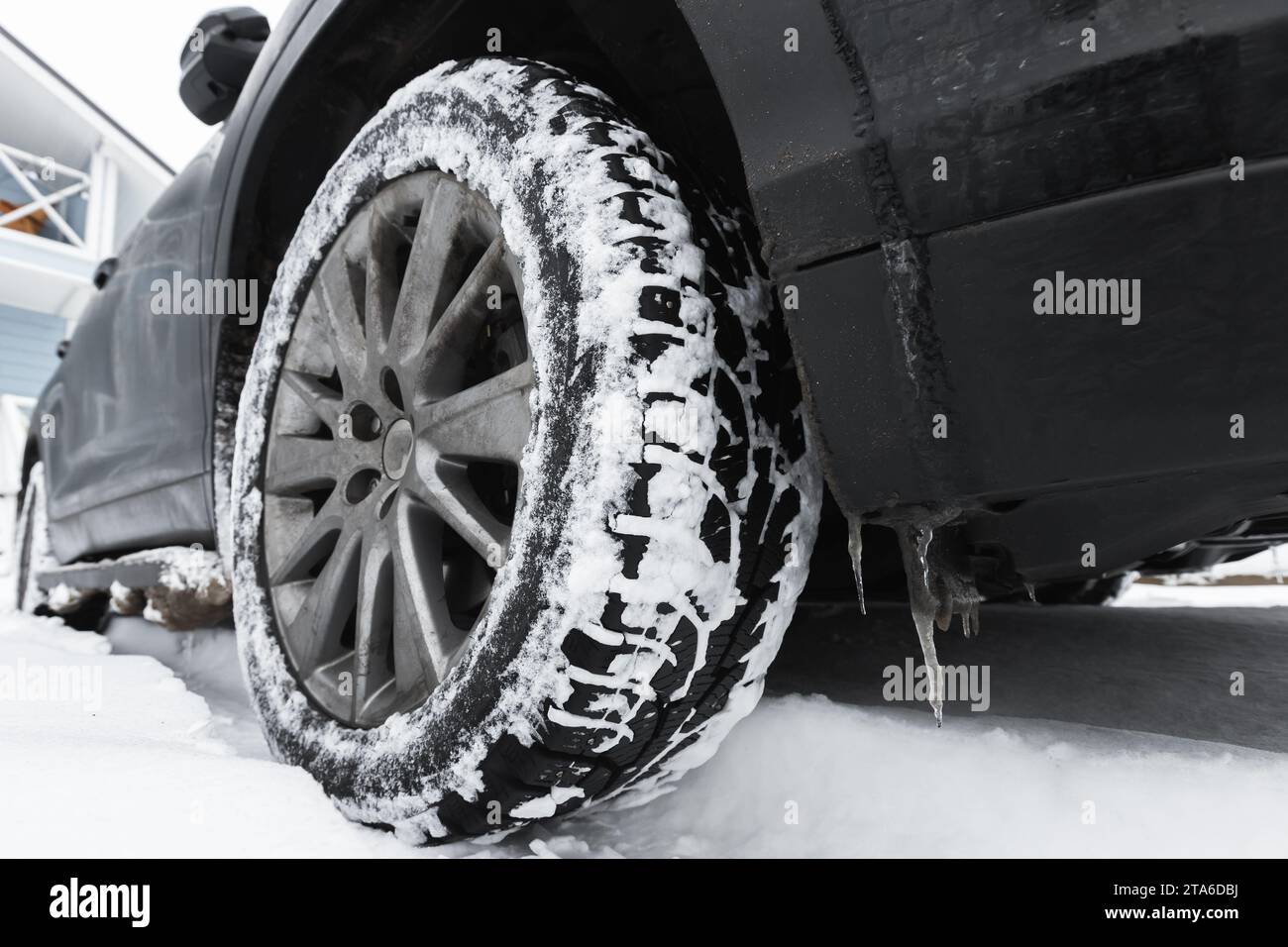 Close-up photo of a SUV car wheel on snow tire with metal studs Stock Photo