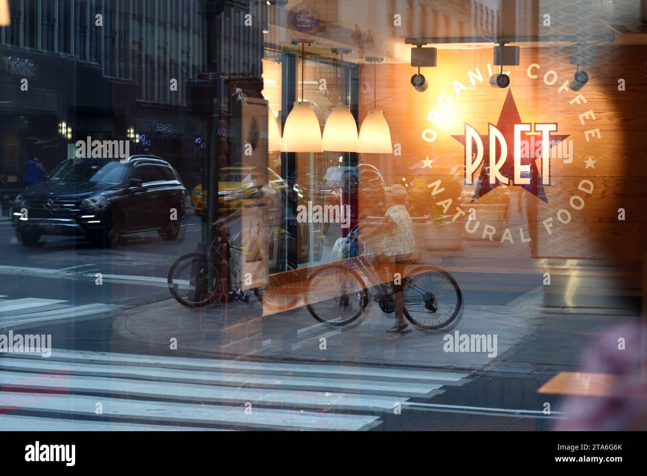 New York, USA - May 26, 2018: Fast casual restaurant Pret A Manger logo with reflection the street of  New York. Stock Photo