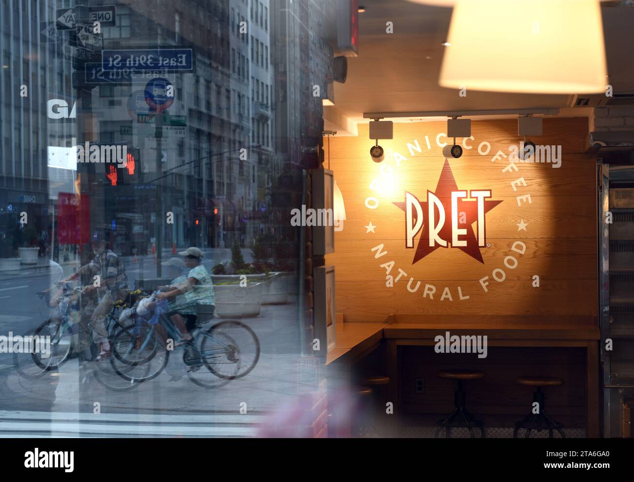 New York, USA - May 26, 2018: Fast casual restaurant Pret A Manger logo with reflection the street of  New York. Stock Photo