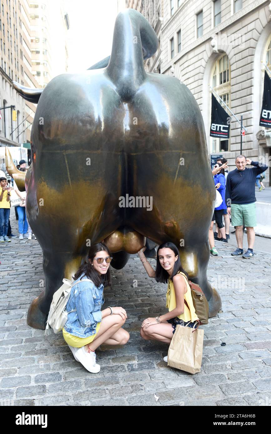 New York, USA - May 2018: People near the Charging Bull sculpture in New York. Stock Photo