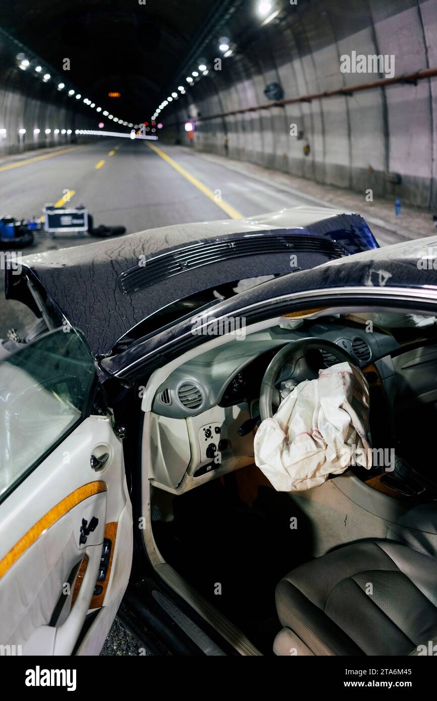 Traffic accident. Frontal car crash inside a tunnel. Crumpled bumper