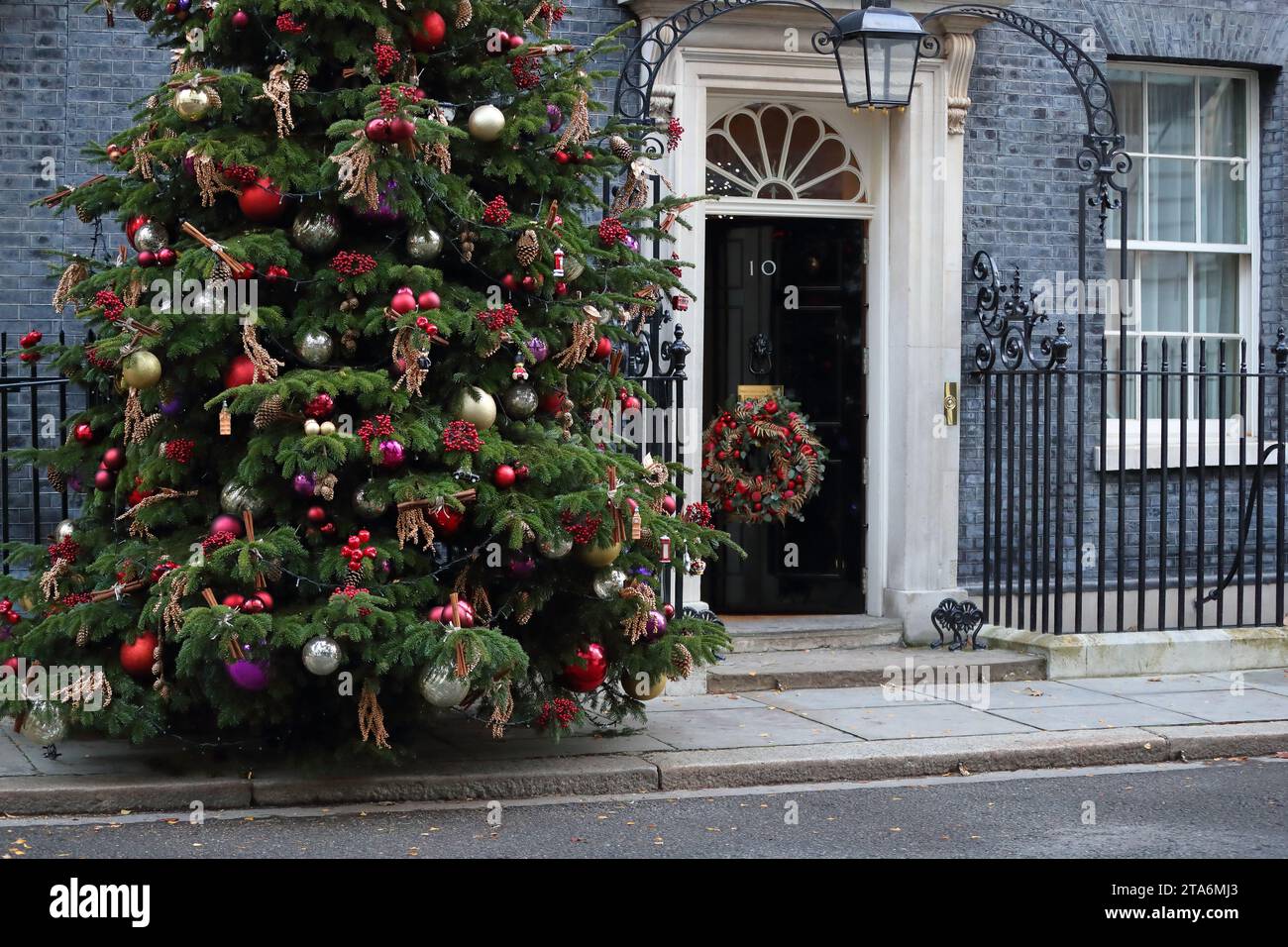 London, United Kingdom. 28th Nov, 2023. The entrance to No 10 Downing Street is decorated with a traditional Christmas tree and a wreath on the door. Stock Photo