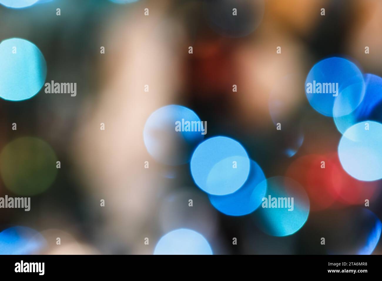 Blue and gold Christmas garland  bokeh lights on a tree, abstract multi colored blurred background. Stock Photo