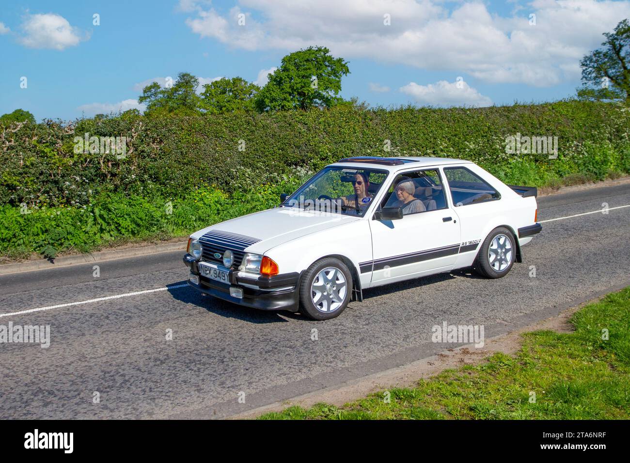 1983 80s eighties White Ford Escort GL RS1600, 1597 cc 5 speed manual car; Vintage, restored classic motors, automobile collectors motoring enthusiasts, historic veteran cars travelling in Cheshire, UK Stock Photo