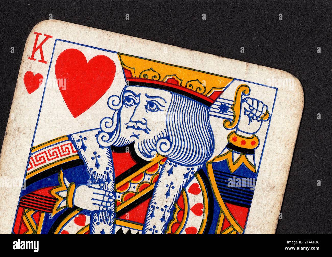 Close up of a vintage king of hearts playing card isolated on a black