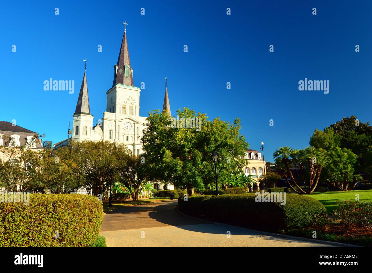 The St Louis Cathedral rises over the trees and park setting of Jackson Square, in the French Quarter of New Orleans Stock Photo