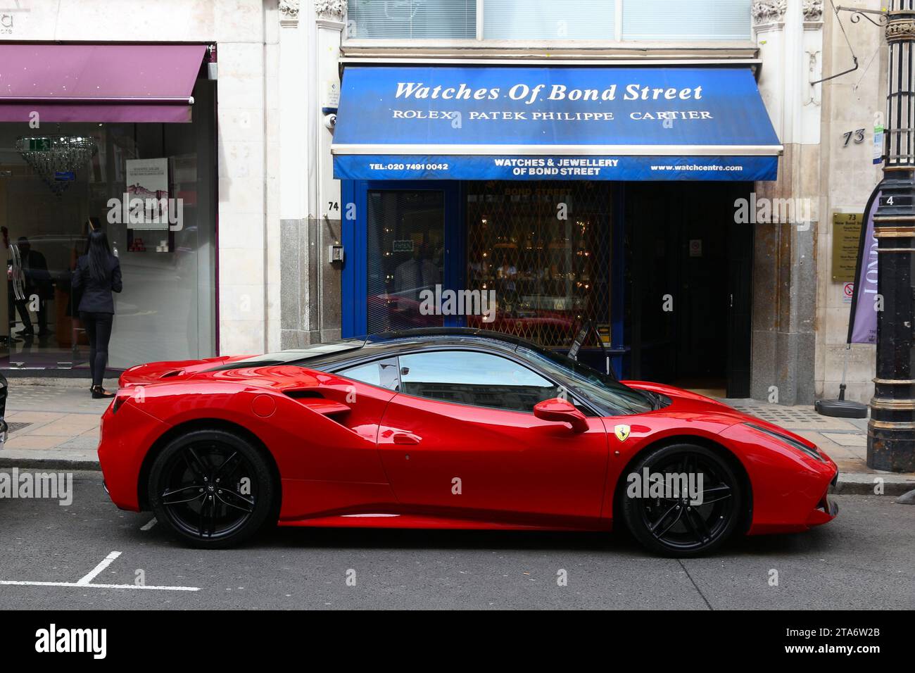 LONDON, UK - JULY 7, 2016: Ferrari sports car parked at New Bond Street in London. Bond Street is a major shopping street in the West End of London. Stock Photo